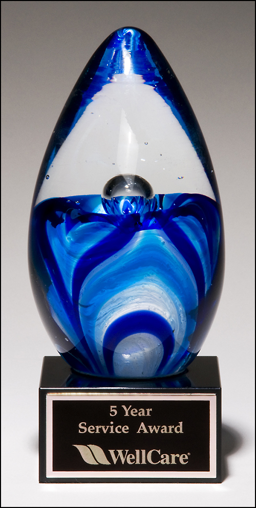 Airflyte Art Glass egg with blue and white accents on black glass base with Black Laser Plate